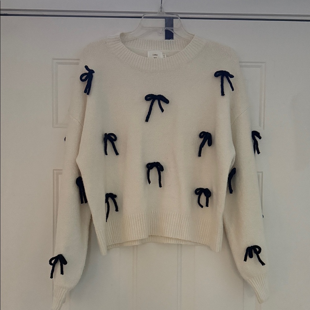 Elegant Cream Sweater with Black Bow Details